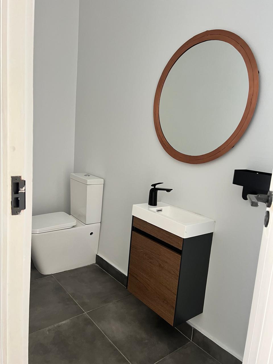 Guest powder room with statement round mirror &mdash; Luxury Home Renovation, Mazibuko Trading & Projects