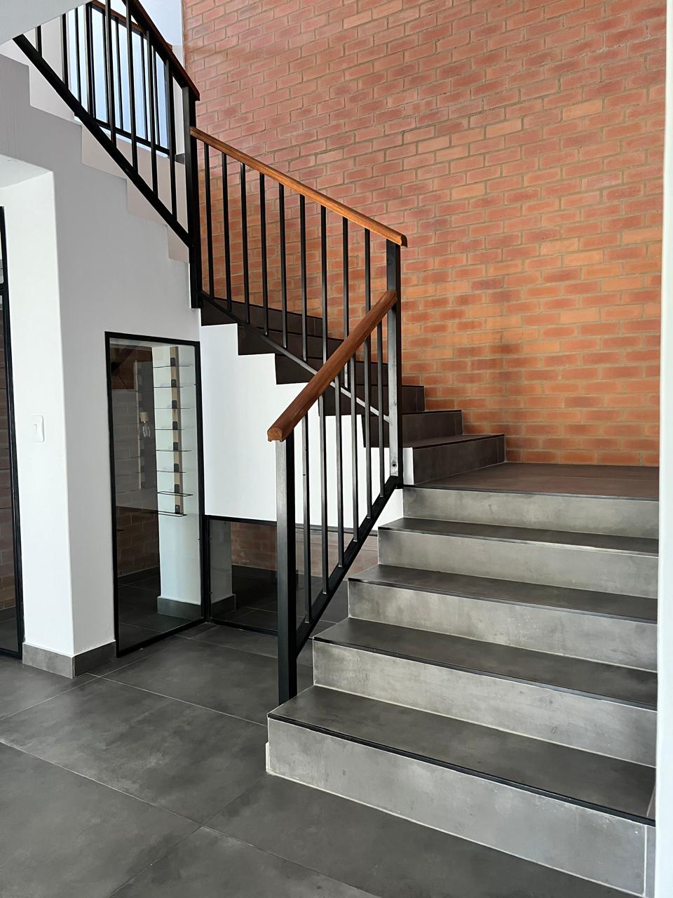 Staircase with exposed brick feature wall &mdash; Luxury Home Renovation, Mazibuko Trading & Projects