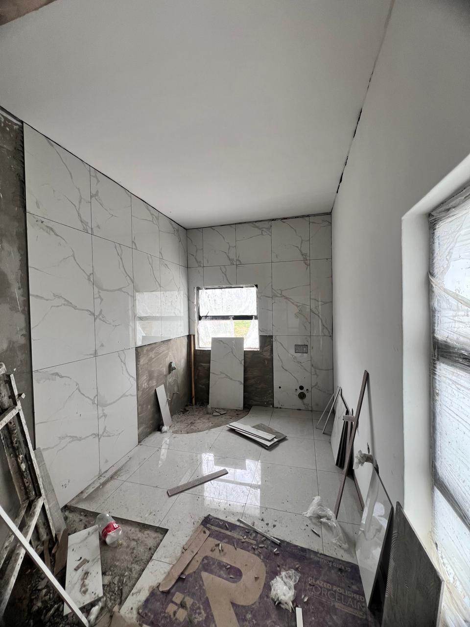 Bathroom wall tiling in progress &mdash; Residential Renovation Project, Mazibuko Trading & Projects